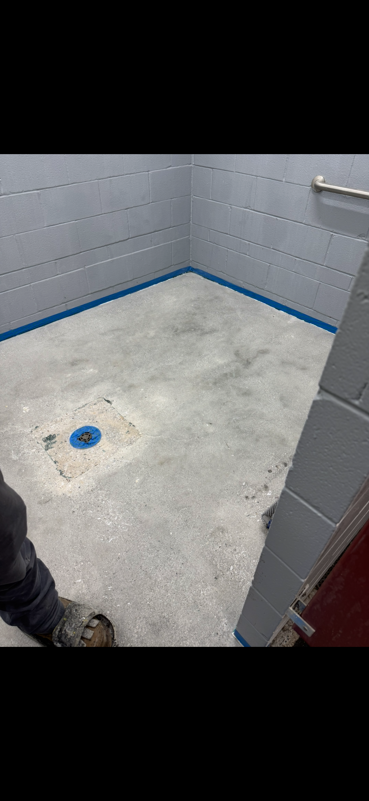 Before: raw concrete bathroom floor