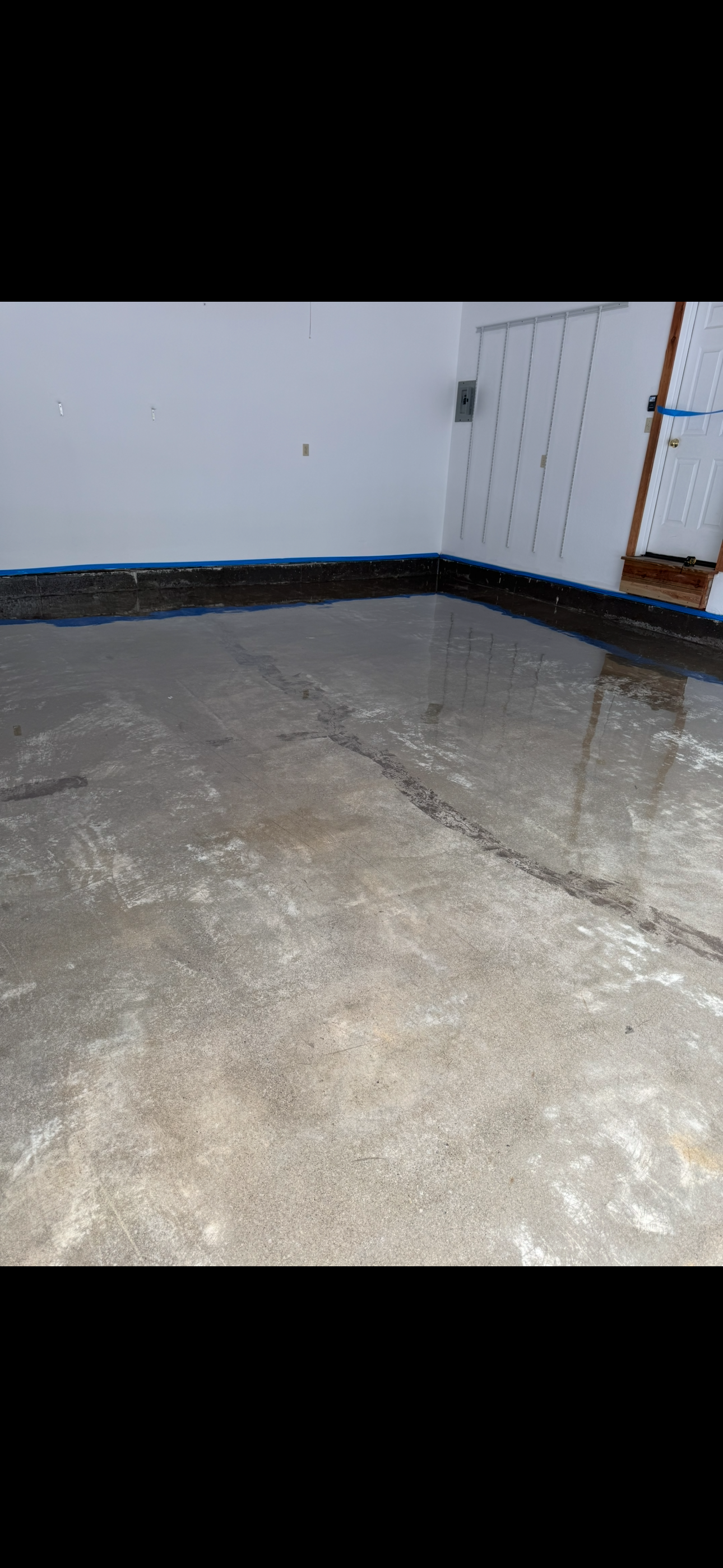 Before: large garage with damaged concrete